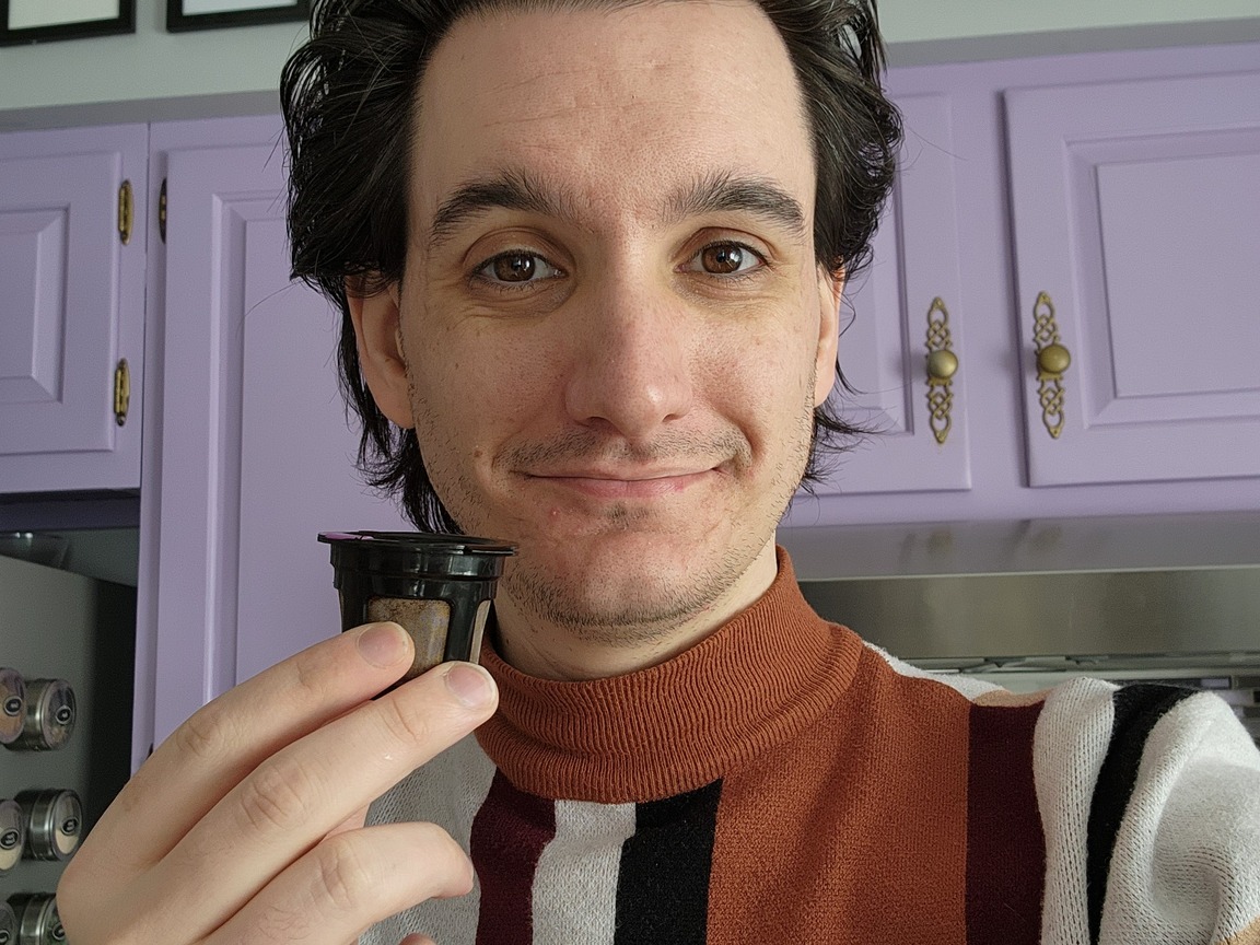 Louis Greubel holding up a reusable K-Cup